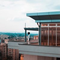 Man Standing on Balcony