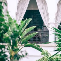 White arched balcony with metal railings